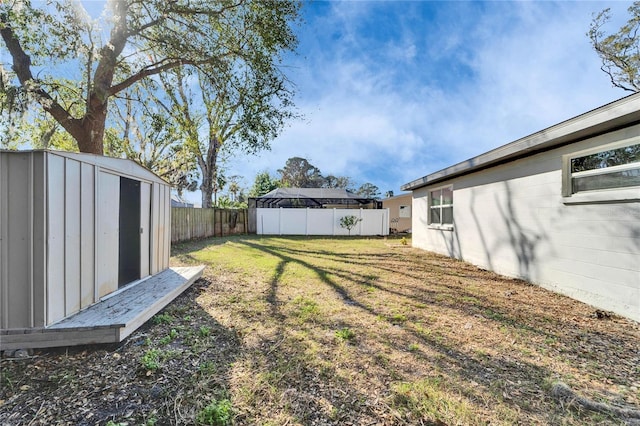 view of yard with a swimming pool and a shed