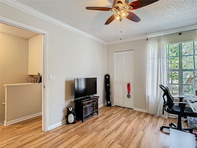 office featuring ornamental molding, ceiling fan, a textured ceiling, and light wood-type flooring