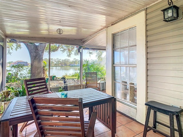 sunroom with a water view and wood ceiling