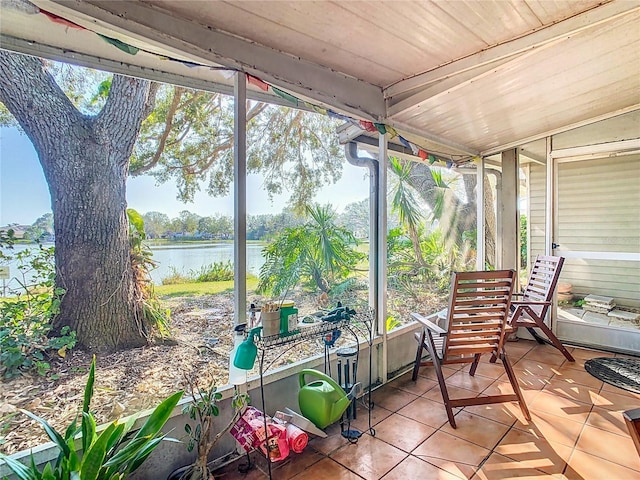 sunroom / solarium featuring a water view and wood ceiling