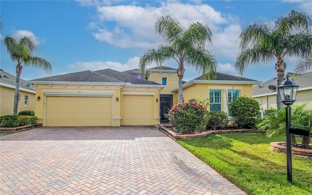 view of front of property featuring a garage and a front lawn