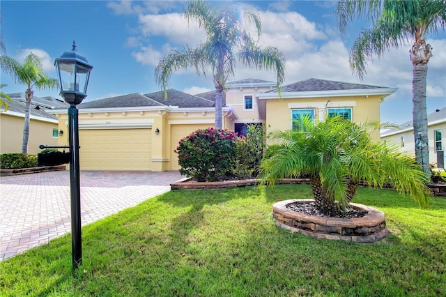 view of front facade with a garage and a front lawn