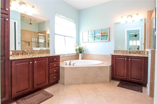 bathroom featuring tile patterned flooring, vanity, and separate shower and tub