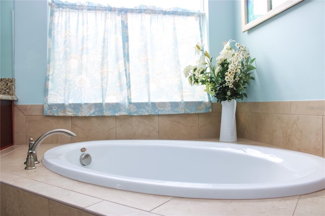 bathroom featuring vanity and tiled bath