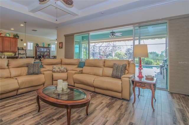 living room featuring crown molding, hardwood / wood-style flooring, ceiling fan, beam ceiling, and coffered ceiling