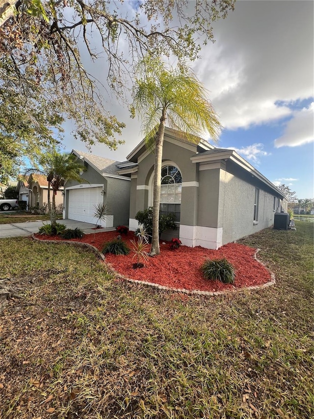 view of front of property featuring a garage and a front lawn