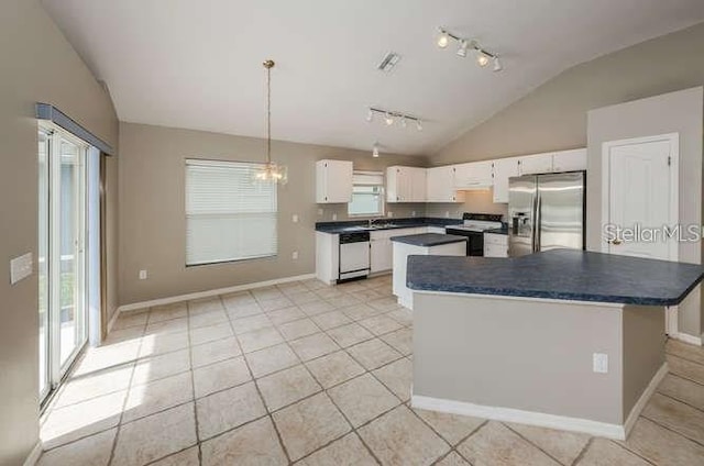 kitchen with white cabinetry, appliances with stainless steel finishes, vaulted ceiling, and a kitchen island