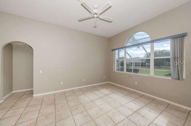 tiled empty room with ceiling fan