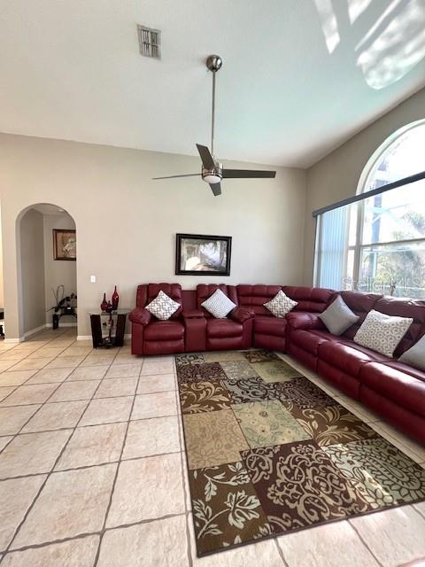 tiled living room featuring ceiling fan