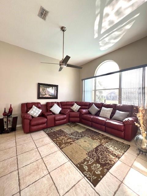 tiled living room with ceiling fan