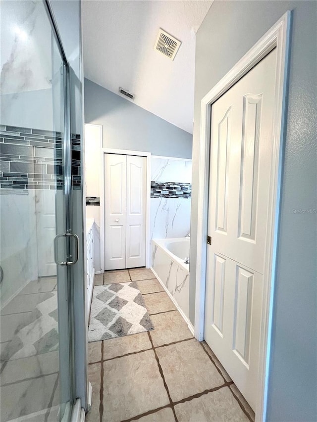 bathroom featuring lofted ceiling, plus walk in shower, and vanity