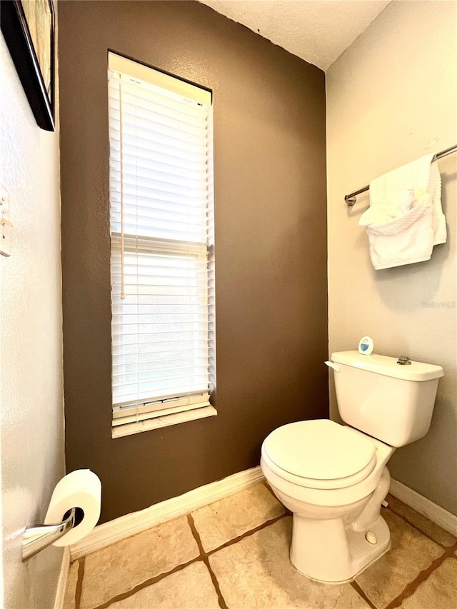 bathroom with tile patterned flooring and toilet