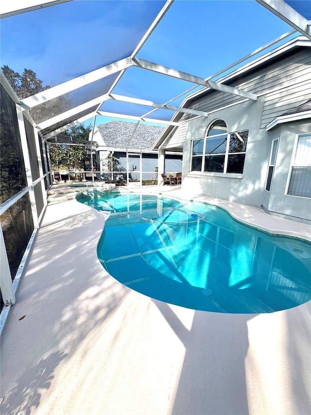 view of pool featuring a patio and glass enclosure