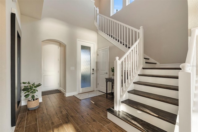 entrance foyer with a high ceiling and dark hardwood / wood-style floors