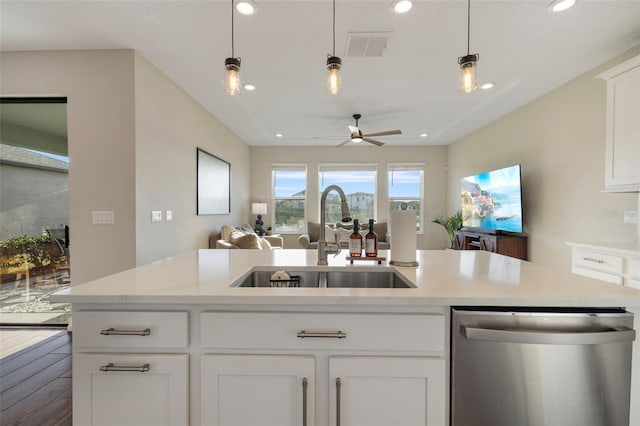 kitchen with pendant lighting, dishwasher, sink, and white cabinets