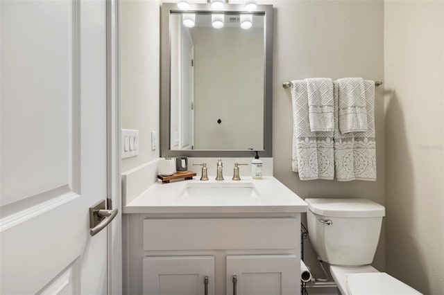 bathroom featuring vanity and toilet