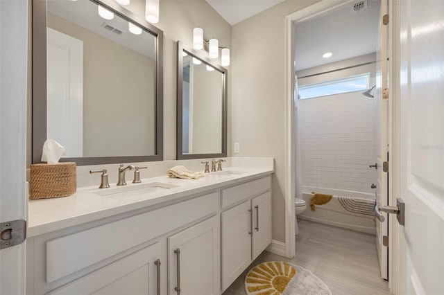 full bathroom featuring vanity, toilet, tile patterned flooring, and shower / bath combo