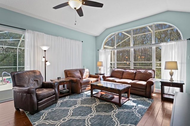 living area featuring a sunroom, hardwood / wood-style flooring, ceiling fan, and vaulted ceiling