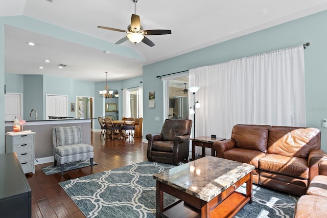 living area with visible vents, dark wood-type flooring, baseboards, recessed lighting, and ceiling fan with notable chandelier