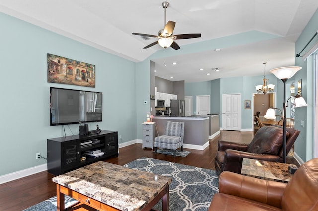 living room featuring lofted ceiling, ceiling fan with notable chandelier, dark wood finished floors, recessed lighting, and baseboards