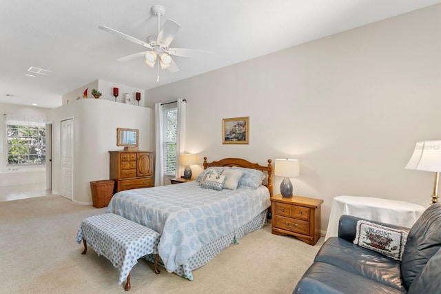 bedroom featuring baseboards, light colored carpet, a closet, and ceiling fan