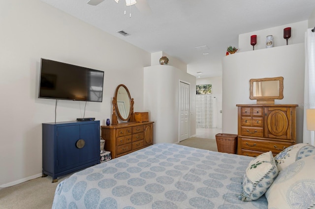 carpeted bedroom featuring visible vents, connected bathroom, baseboards, a closet, and a ceiling fan