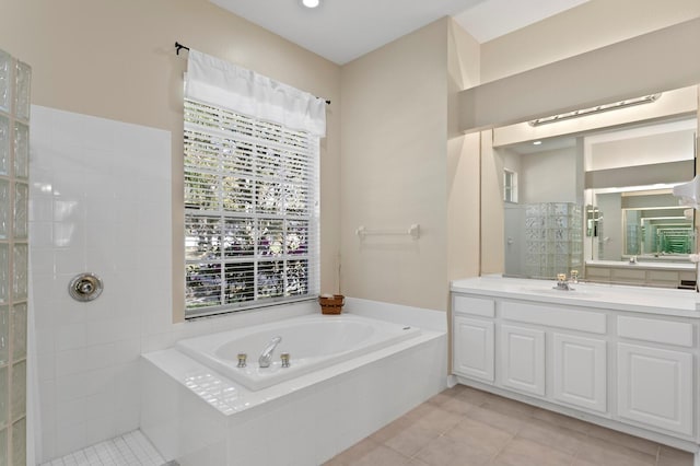 full bath with vanity, tile patterned floors, a bath, and walk in shower