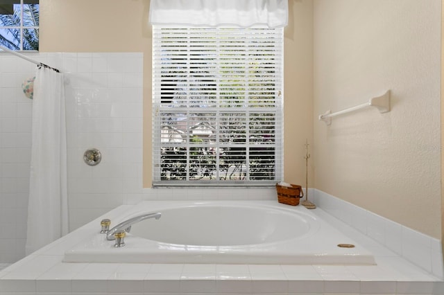 full bath featuring tiled shower and a garden tub