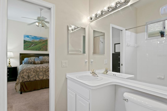 ensuite bathroom featuring toilet, a ceiling fan, connected bathroom, a shower, and vanity