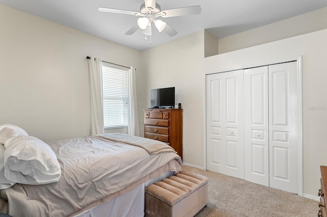 bedroom with a ceiling fan, a closet, carpet floors, and baseboards