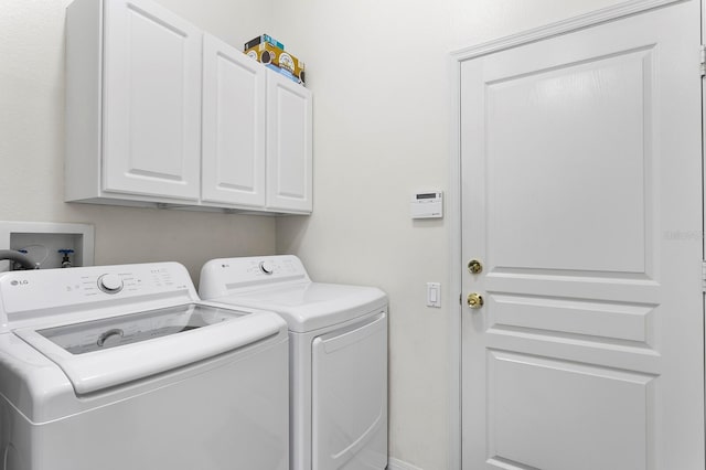 laundry room featuring washer and clothes dryer and cabinet space