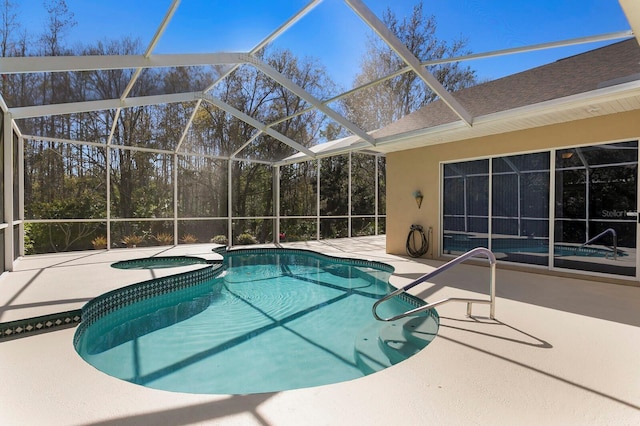 view of swimming pool with a lanai, a pool with connected hot tub, and a patio