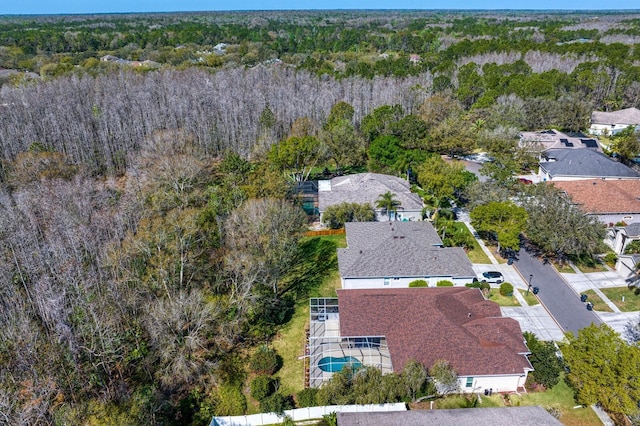 birds eye view of property with a wooded view