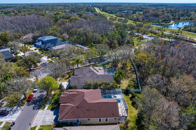 birds eye view of property with a forest view and a water view