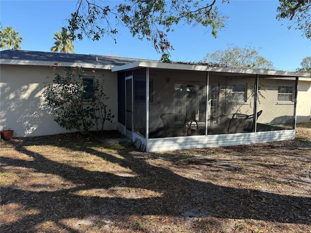 back of house featuring a sunroom