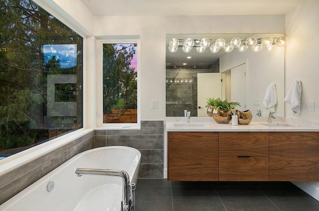 bathroom featuring vanity, tile patterned flooring, shower with separate bathtub, and tile walls