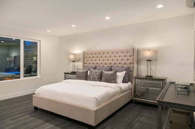 bedroom featuring dark hardwood / wood-style floors and a wall unit AC