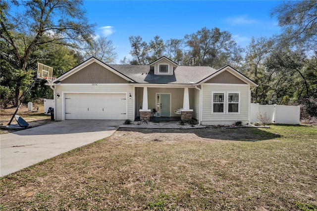 craftsman house with a garage and a front lawn