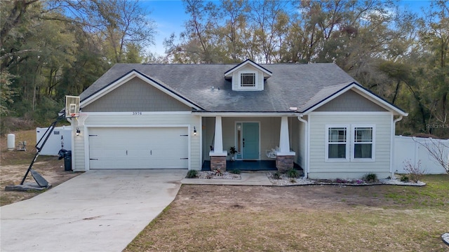 craftsman house with a garage, a front yard, and a porch