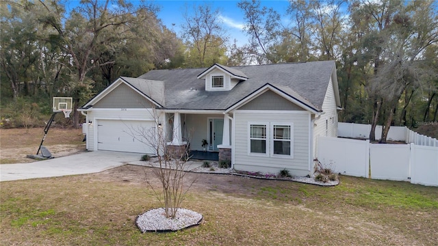 view of front facade with a porch, a garage, and a front lawn