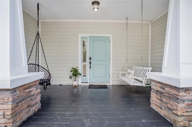 view of exterior entry featuring a porch