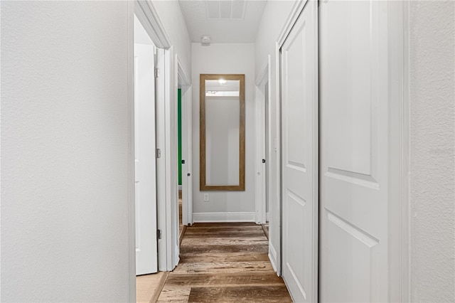 hall with hardwood / wood-style floors