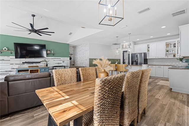 dining area with lofted ceiling, light hardwood / wood-style floors, and ceiling fan