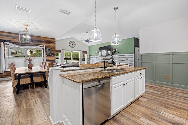 kitchen with sink, light hardwood / wood-style flooring, dishwasher, white cabinets, and a center island with sink