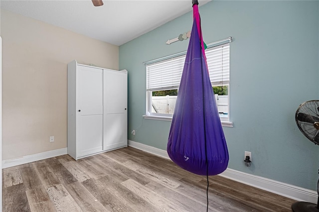 unfurnished bedroom featuring wood-type flooring, a closet, and ceiling fan