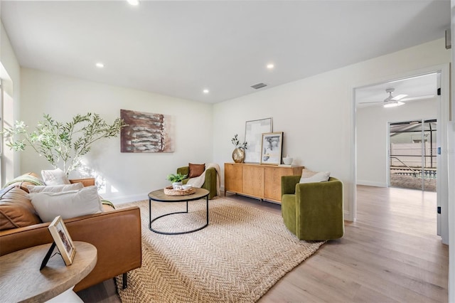 sitting room with ceiling fan and light hardwood / wood-style flooring