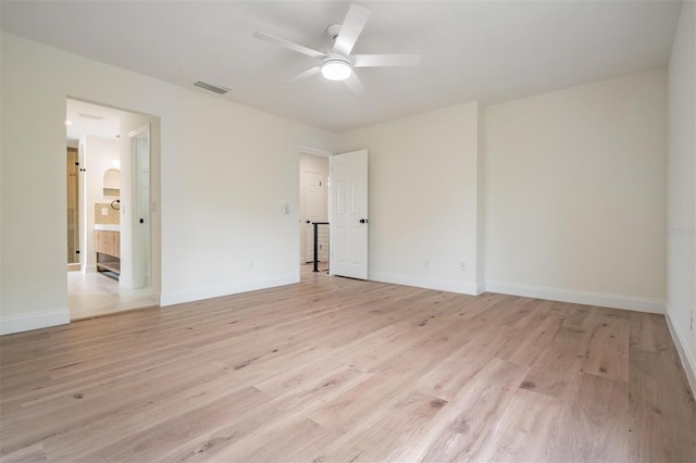 empty room with ceiling fan and light hardwood / wood-style floors