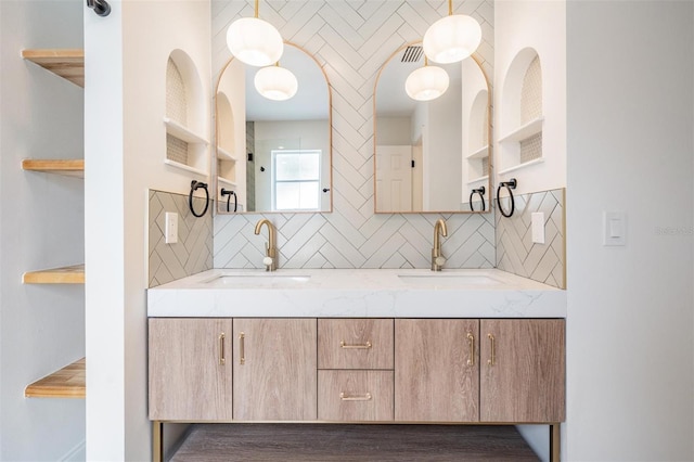 bathroom with tasteful backsplash and vanity