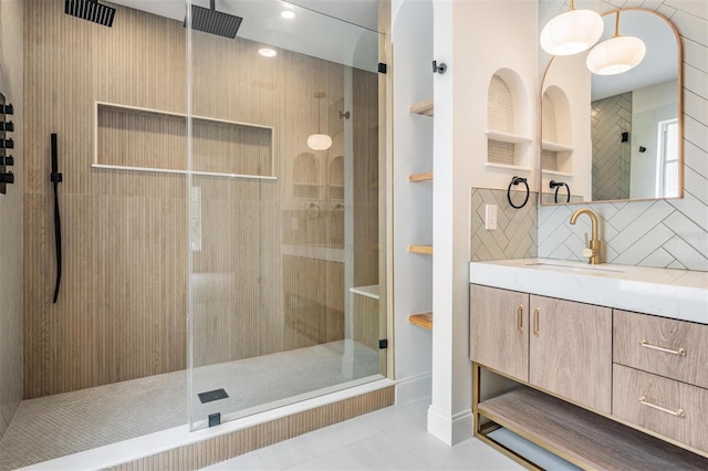 bathroom featuring vanity, tile patterned floors, an enclosed shower, and backsplash