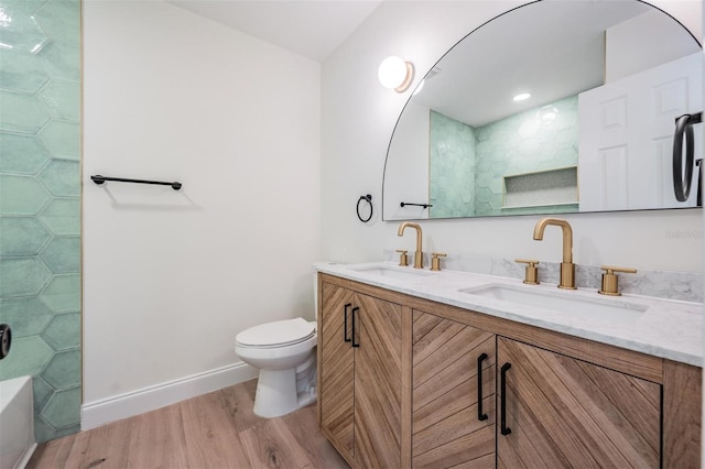 bathroom featuring vanity, hardwood / wood-style floors, a shower, and toilet